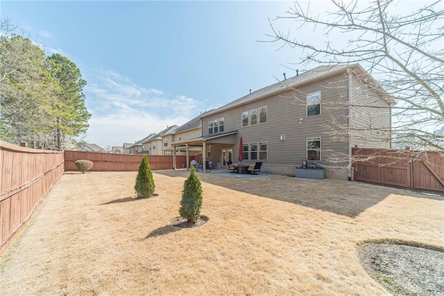 back of house featuring a fenced backyard and a patio area