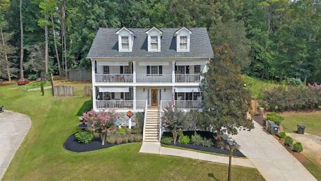 view of front of home with a front lawn and a balcony