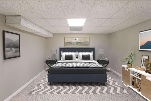 bedroom with carpet flooring and a drop ceiling