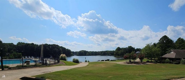 exterior space with a water view and a lawn