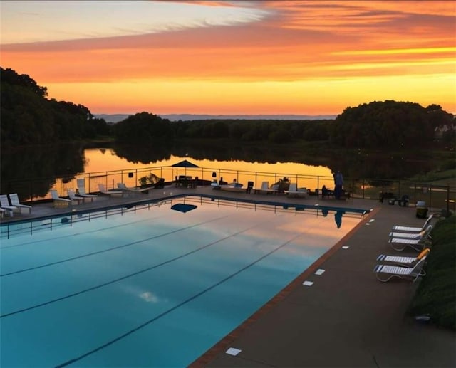 pool at dusk with a water view