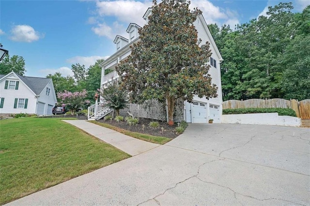 view of property exterior featuring a lawn and a garage