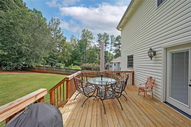 wooden terrace with a lawn