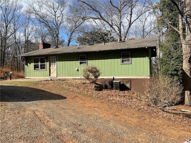 view of front of house featuring a chimney and cooling unit