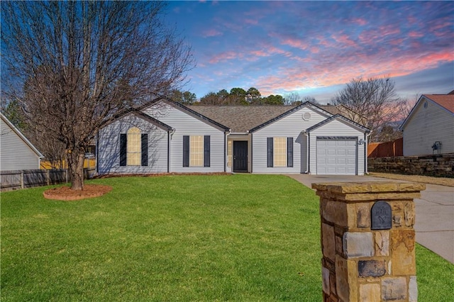 ranch-style house featuring a garage and a lawn