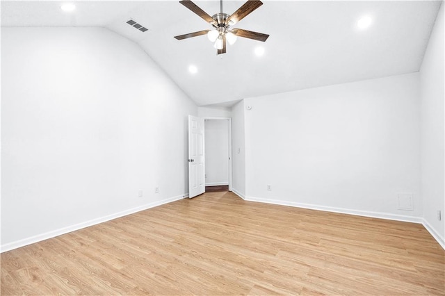 spare room with ceiling fan, lofted ceiling, and light wood-type flooring