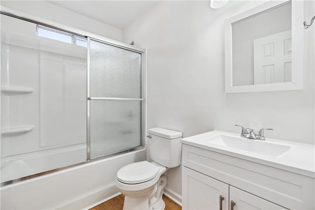 full bathroom with vanity, combined bath / shower with glass door, wood-type flooring, and toilet