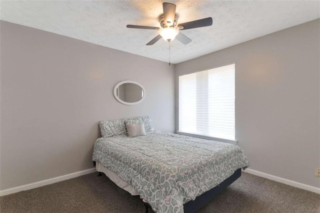 bedroom featuring baseboards, carpet floors, and a textured ceiling