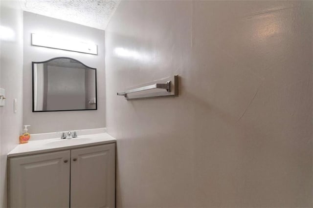 bathroom with a textured ceiling and vanity