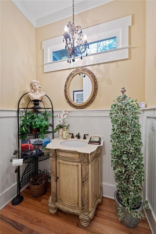 bathroom featuring hardwood / wood-style floors, a notable chandelier, and vanity