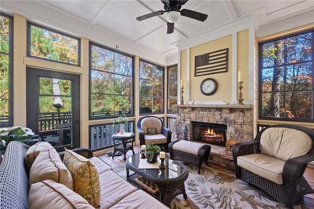 sunroom / solarium with coffered ceiling, a fireplace, and ceiling fan