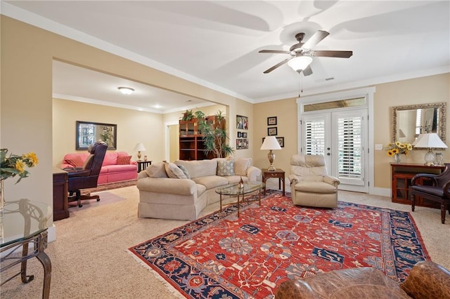 carpeted living room featuring ceiling fan, crown molding, and french doors