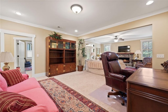 home office featuring ceiling fan, ornamental molding, and light carpet