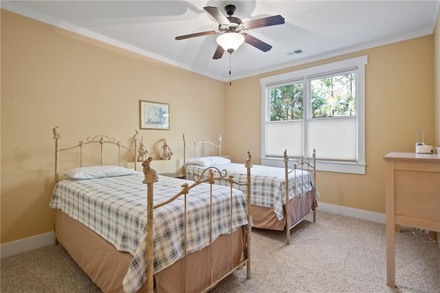 bedroom featuring crown molding, light colored carpet, and ceiling fan