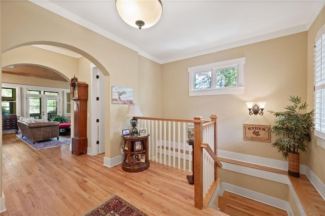 hallway featuring light hardwood / wood-style floors and crown molding