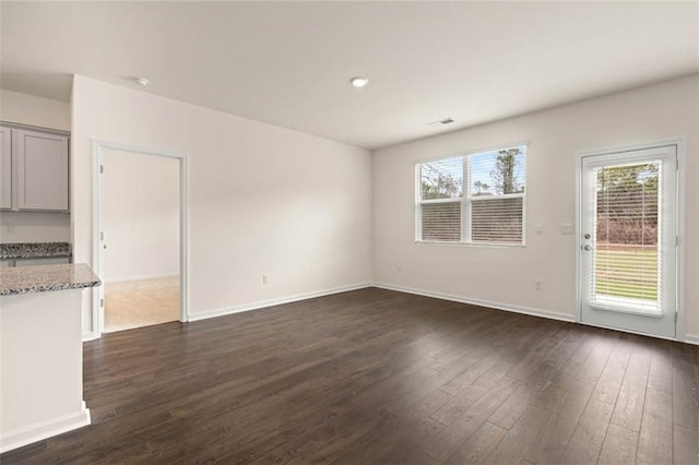 unfurnished living room featuring dark hardwood / wood-style flooring