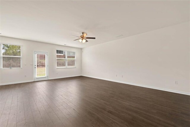 unfurnished living room featuring ceiling fan, dark hardwood / wood-style flooring, and sink