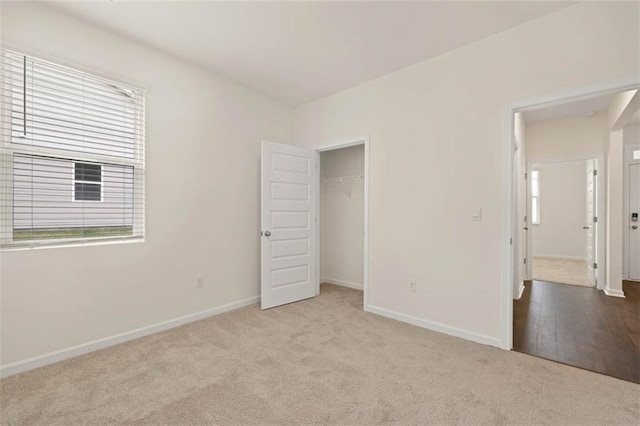 unfurnished bedroom featuring a closet, carpet, and baseboards