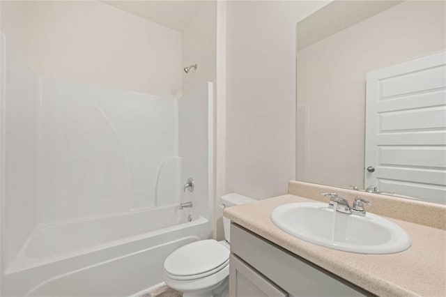 bathroom with tub / shower combination, vanity, and toilet