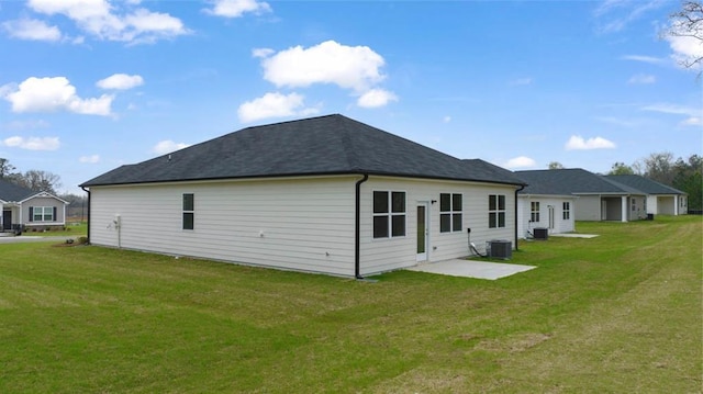 back of house featuring central AC, a lawn, and a patio area