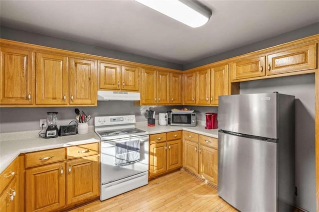 kitchen with appliances with stainless steel finishes and light wood-type flooring