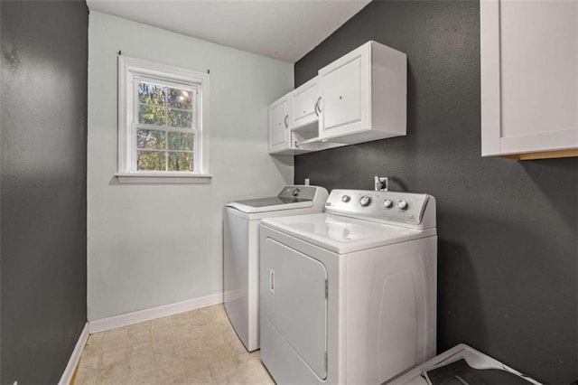 washroom with cabinets and washer and clothes dryer