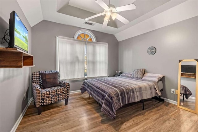 bedroom with ceiling fan, wood-type flooring, and lofted ceiling