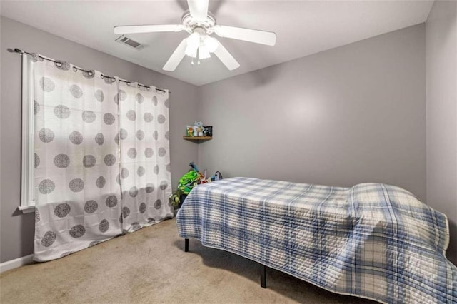 bedroom featuring ceiling fan and carpet