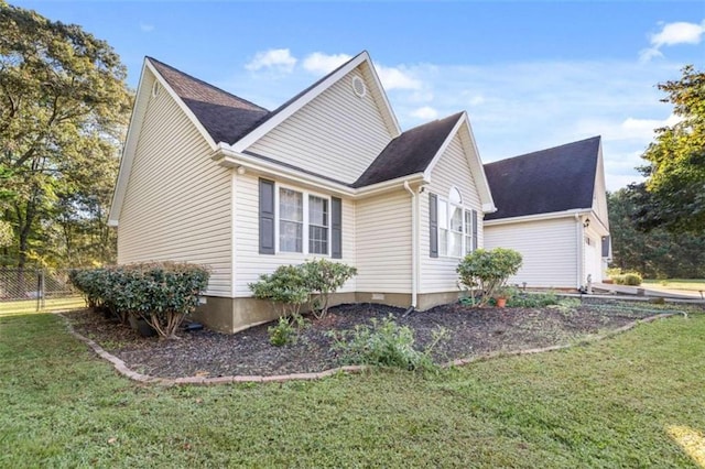 view of side of property with a lawn and a garage