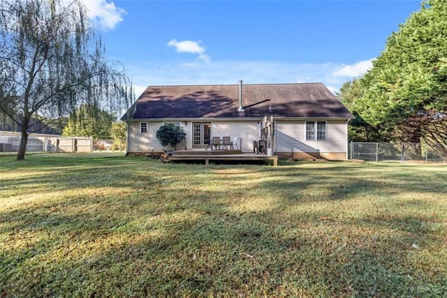 back of house with a wooden deck and a yard