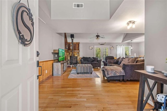 living room with light hardwood / wood-style flooring and ceiling fan