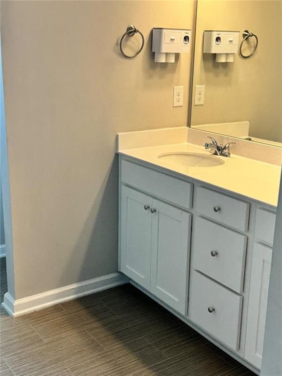 bathroom with vanity and baseboards