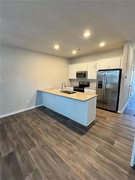 kitchen featuring baseboards, dark wood-style flooring, appliances with stainless steel finishes, and a sink