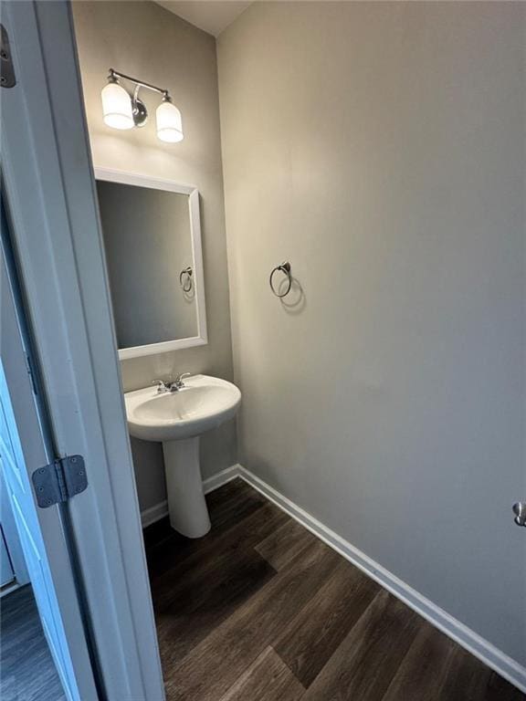 bathroom with baseboards and wood finished floors