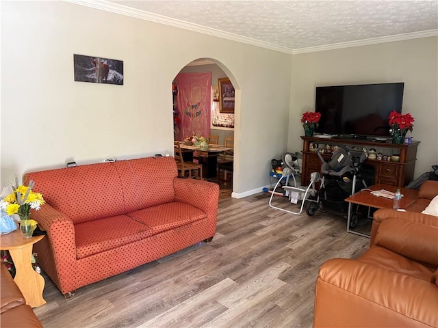703 Jack Sharp Rd, Colbert, GA 30628 - living room with arched walkways, wood finished floors, crown molding, and a textured ceiling
