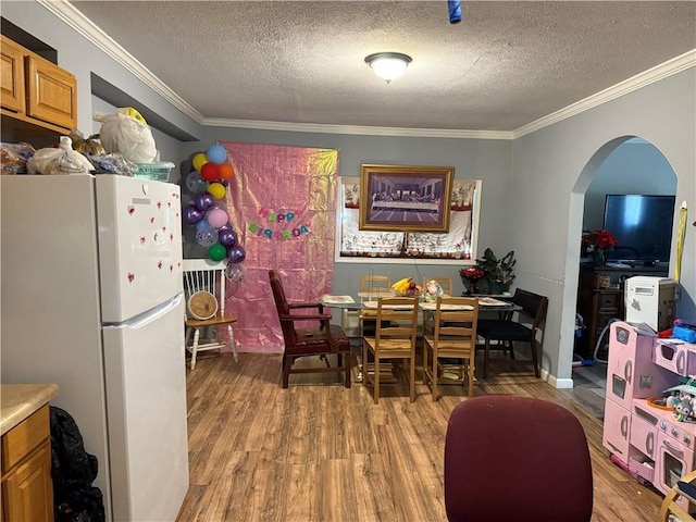 703 Jack Sharp Rd, Colbert, GA 30628 - dining room with ornamental molding, wood finished floors, arched walkways, and a textured ceiling