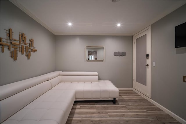 living area with crown molding and hardwood / wood-style floors