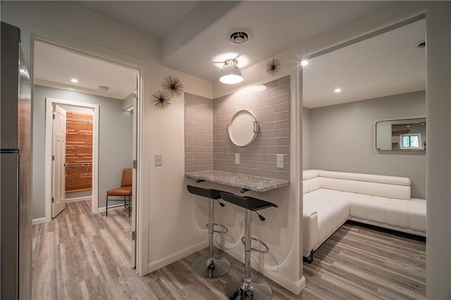 bathroom with tasteful backsplash and hardwood / wood-style flooring