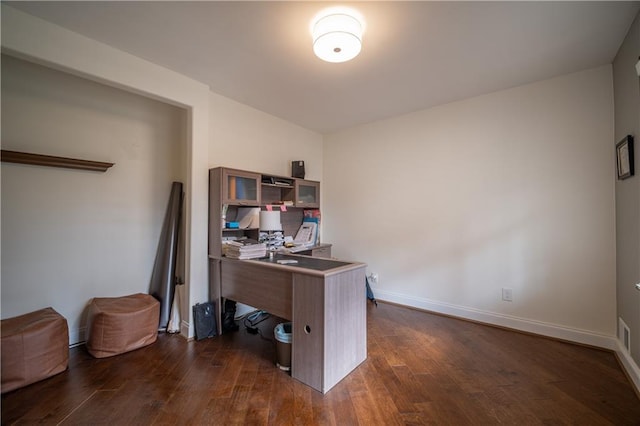 office space with dark wood-type flooring