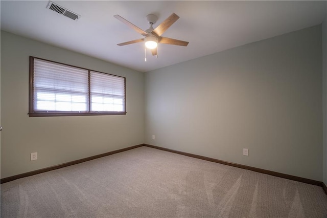 spare room with light colored carpet and ceiling fan