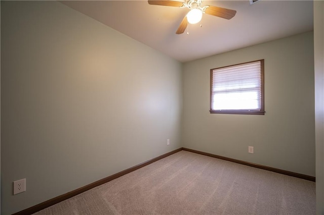 empty room with ceiling fan and carpet flooring