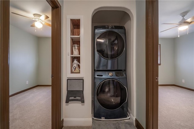 washroom featuring stacked washer and dryer, light carpet, and ceiling fan