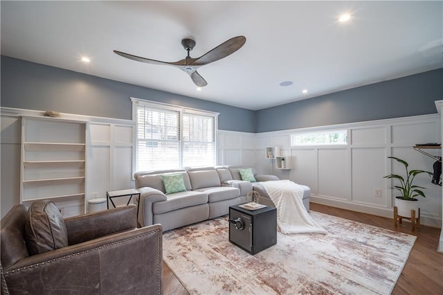 living room with hardwood / wood-style floors, a wealth of natural light, and ceiling fan