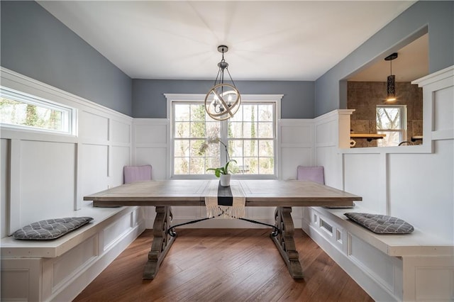 dining room featuring breakfast area, a notable chandelier, and dark hardwood / wood-style floors