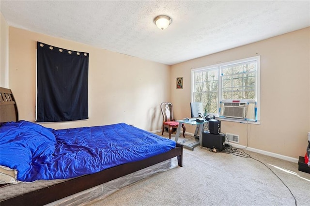 carpeted bedroom with a textured ceiling, cooling unit, visible vents, and baseboards