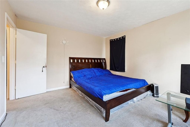 bedroom featuring light carpet and baseboards