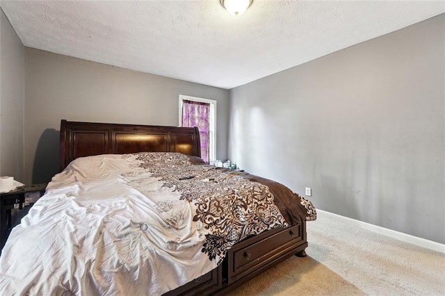 bedroom with baseboards, a textured ceiling, and light colored carpet