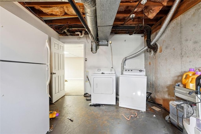 interior space featuring washing machine and clothes dryer and freestanding refrigerator