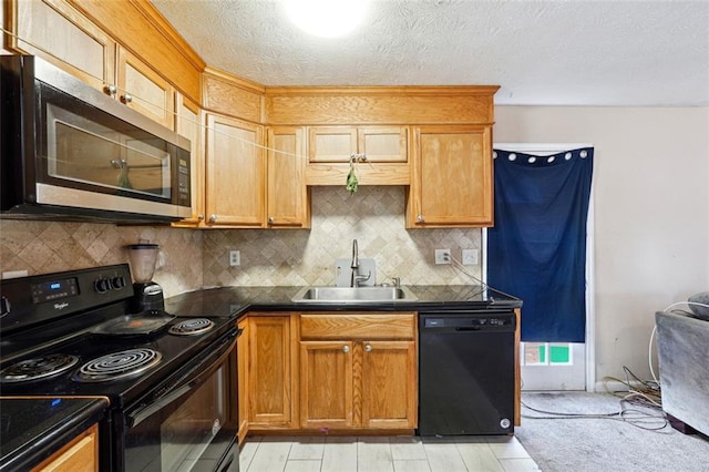 kitchen with decorative backsplash, dark countertops, a textured ceiling, black appliances, and a sink