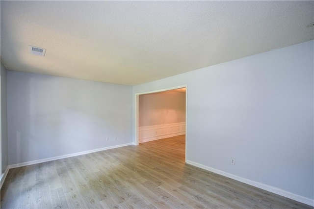 9050 Brockham Way, Alpharetta, GA 30022 - unfurnished room with wood finished floors, baseboards, and a textured ceiling